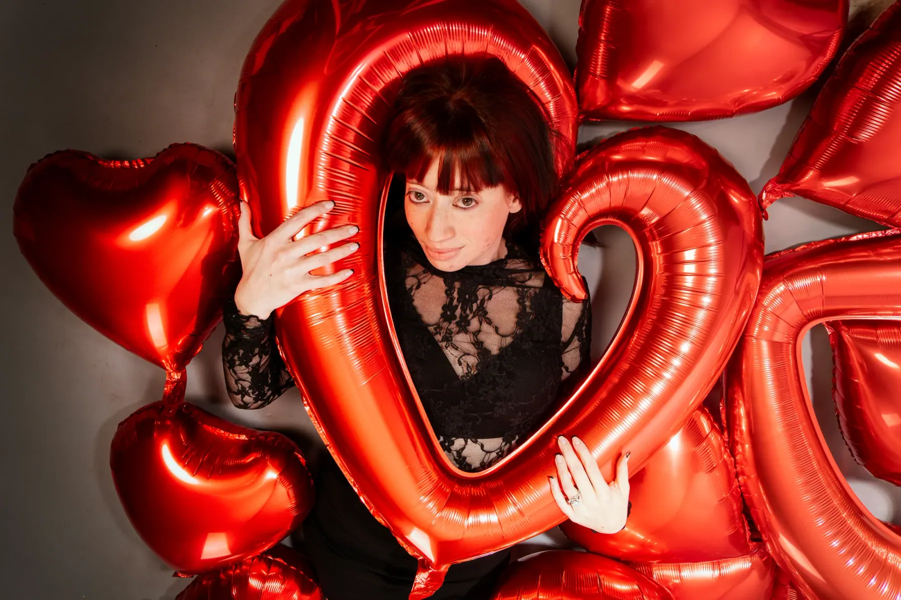 Intimate close portrait in black lace and soft red light
