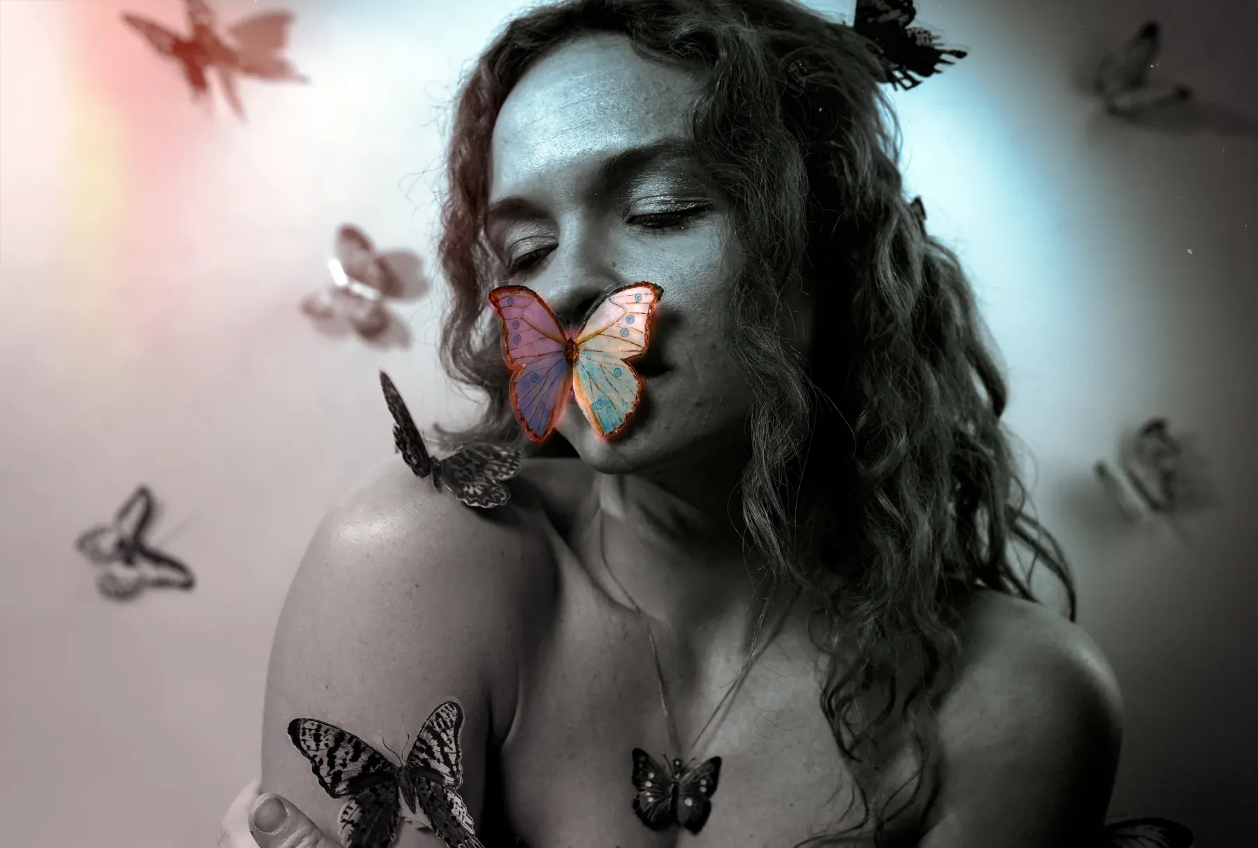 Black and white creative portrait with butterfly accents