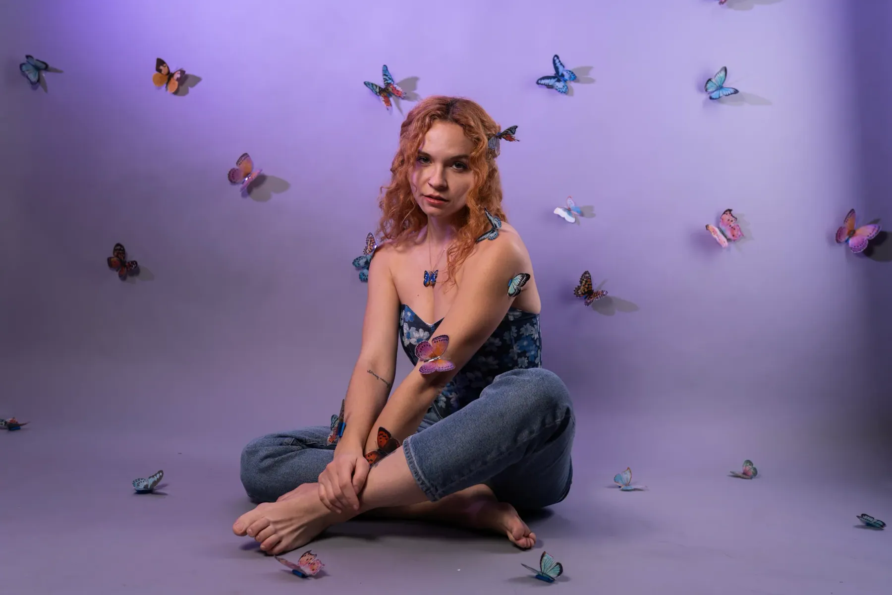 Creative butterfly portrait in a lavender studio scene