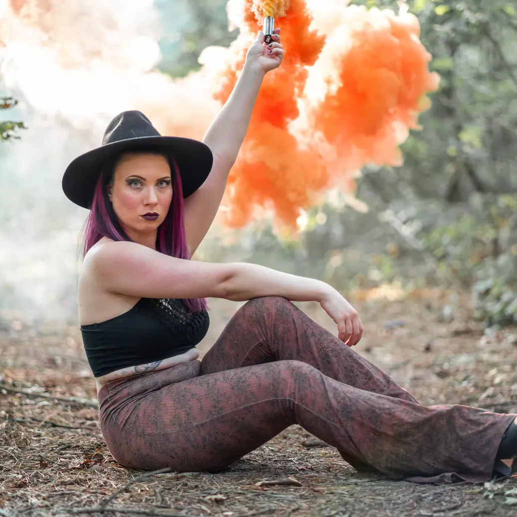 Expressive fashion portrait with a black hat and orange feathers