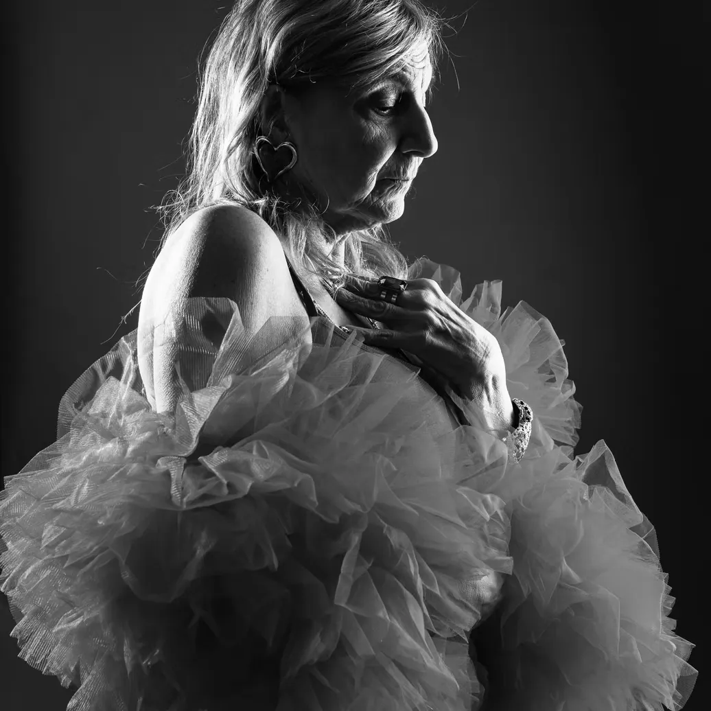 Tender black-and-white maternity portrait in a flowing tulle gown
